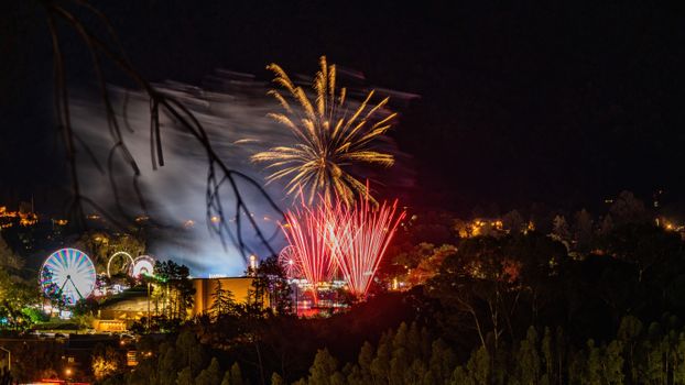 A vibrant fireworks display lighting up the night sky over a city, creating a festive atmosphere.
