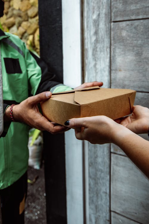 A Man Handing a Package 