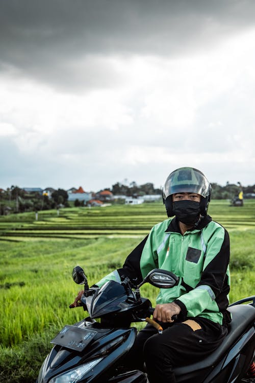 Delivery Man on Motorbike in Field