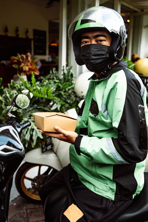 A Biker Holding  a Box of Food