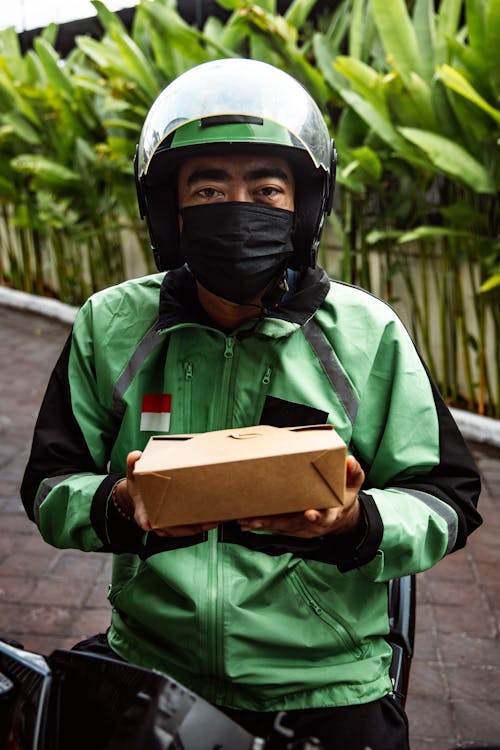 A Delivery Man Holding a Small Box