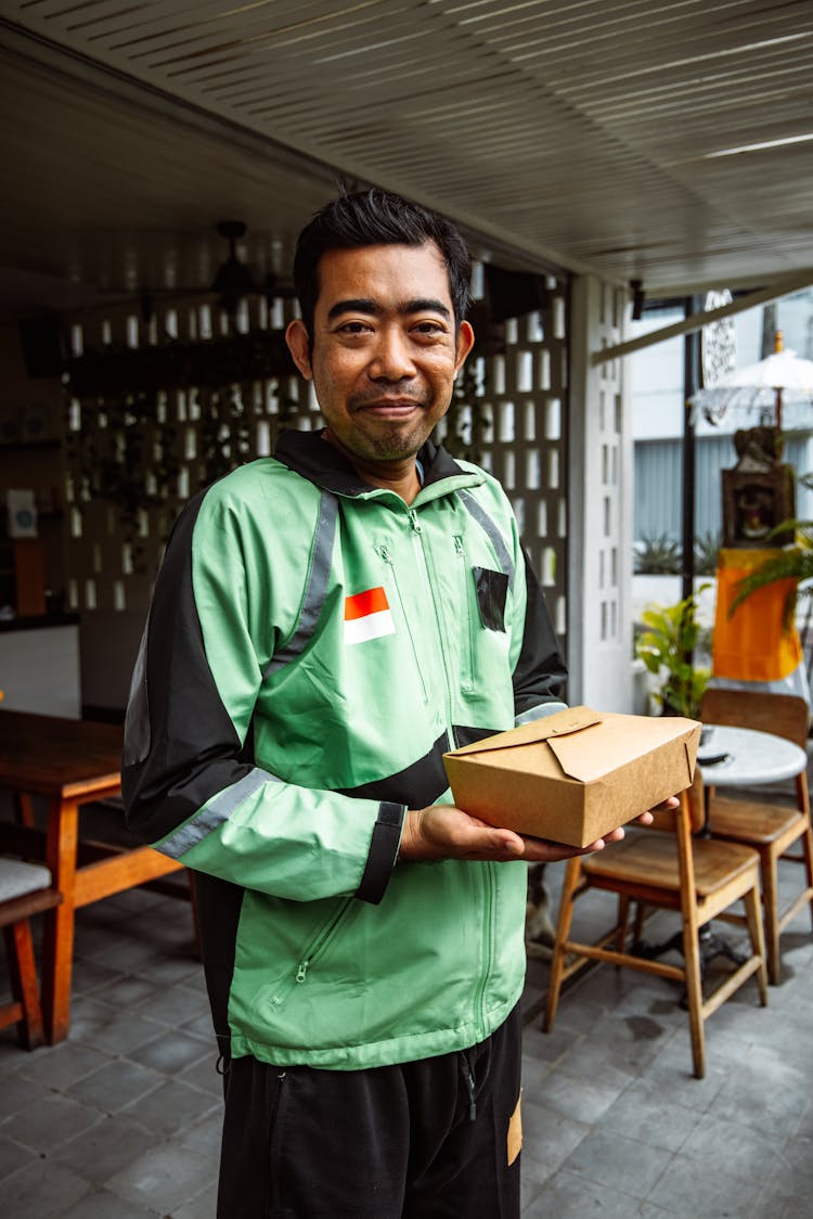 Man In Green Jacket Making Food Delivery