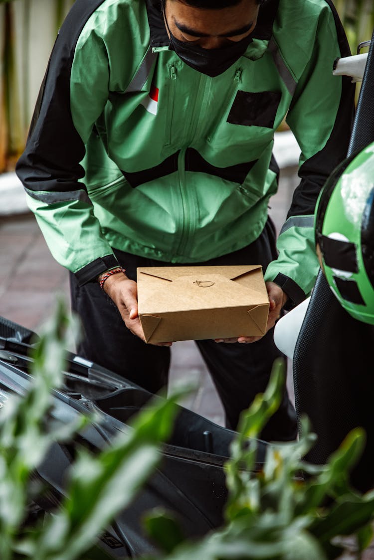 A Man Holding A Package