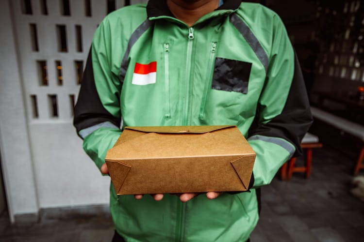 Midsection Of A Person Holding A Package