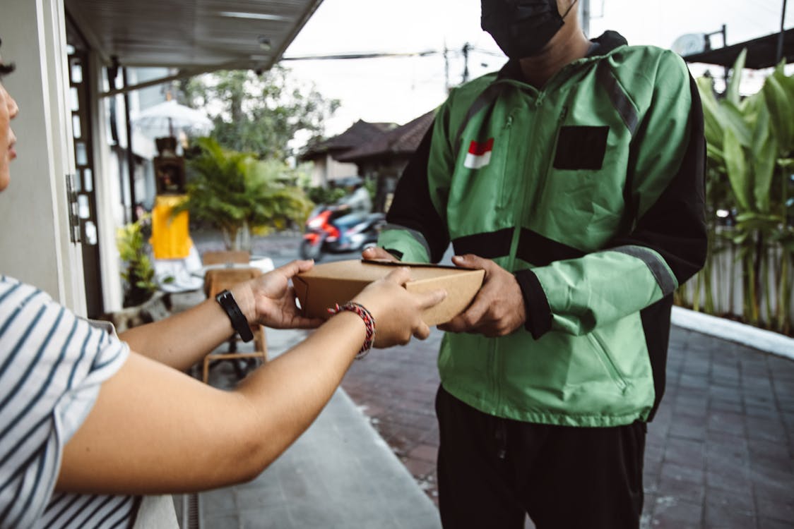 Man Delivering Box to Woman