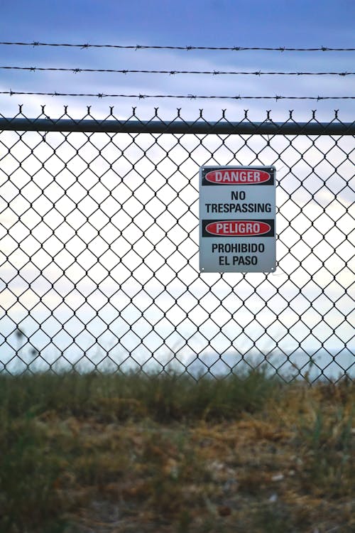 Free No Trespassing Sign on Metal Fence Stock Photo
