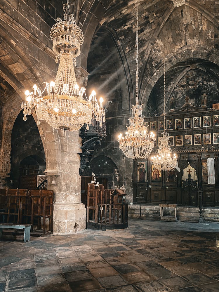 Ornate Chandeliers Hanging From Ceiling In Medieval Chamber