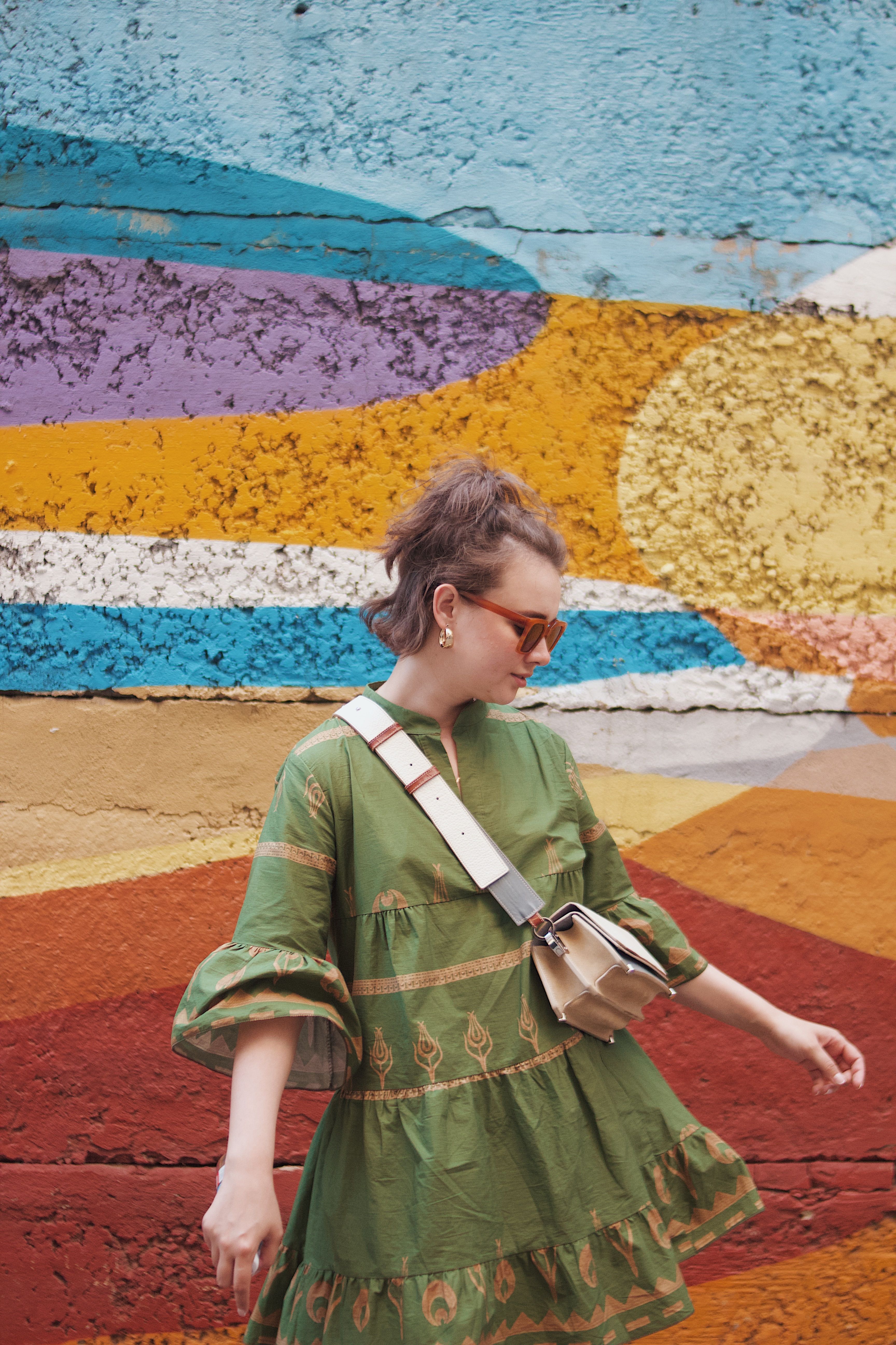 A Woman in a Green Dress Standing by a Mural · Free Stock Photo