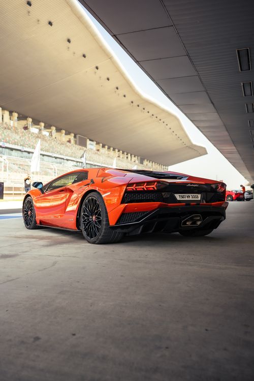 Free Dynamic rear shot of a red Lamborghini Aventador showcasing sleek design and sportscar appeal. Stock Photo