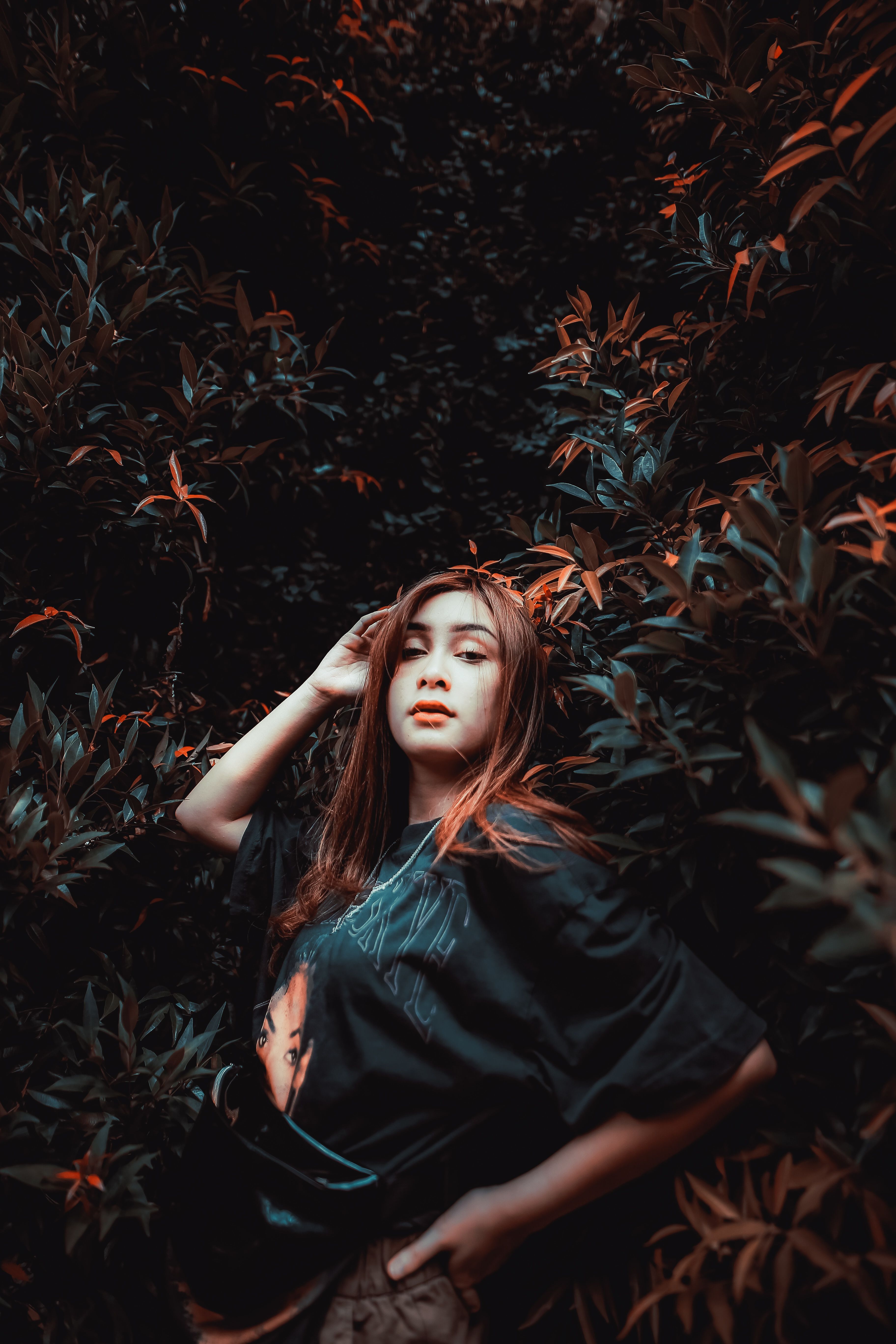 A Woman in Black Shirt Posing with Her Hand on Her Head · Free Stock Photo