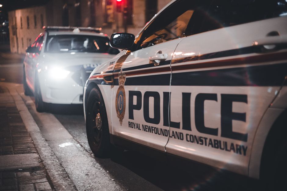 Close-up of Royal Newfoundland Constabulary police cars parked on a street at night.