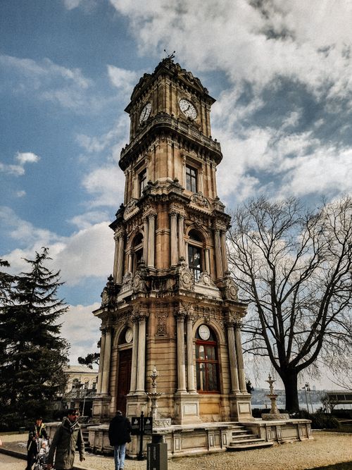 Free Beautiful historic clock tower with ornate facade in a clear blue sky setting. Stock Photo