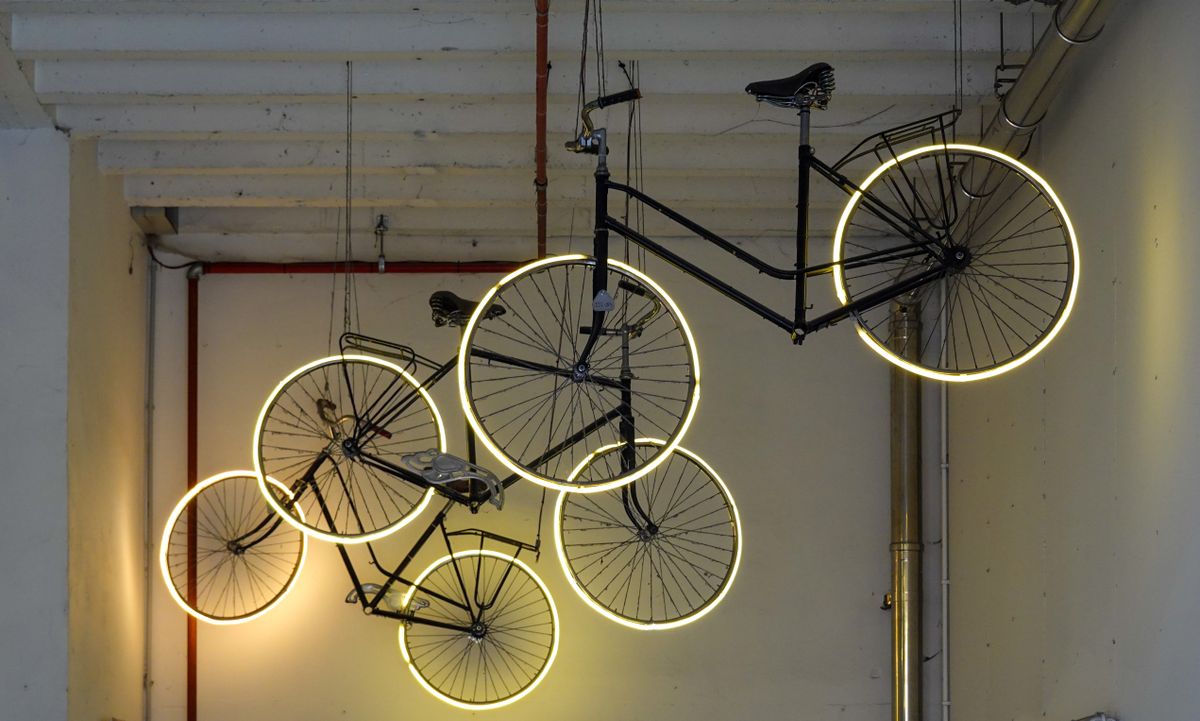 Bicycles hung from the ceiling in an indoor space
