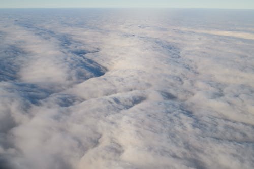 Flying Over White Cumulus Clouds
