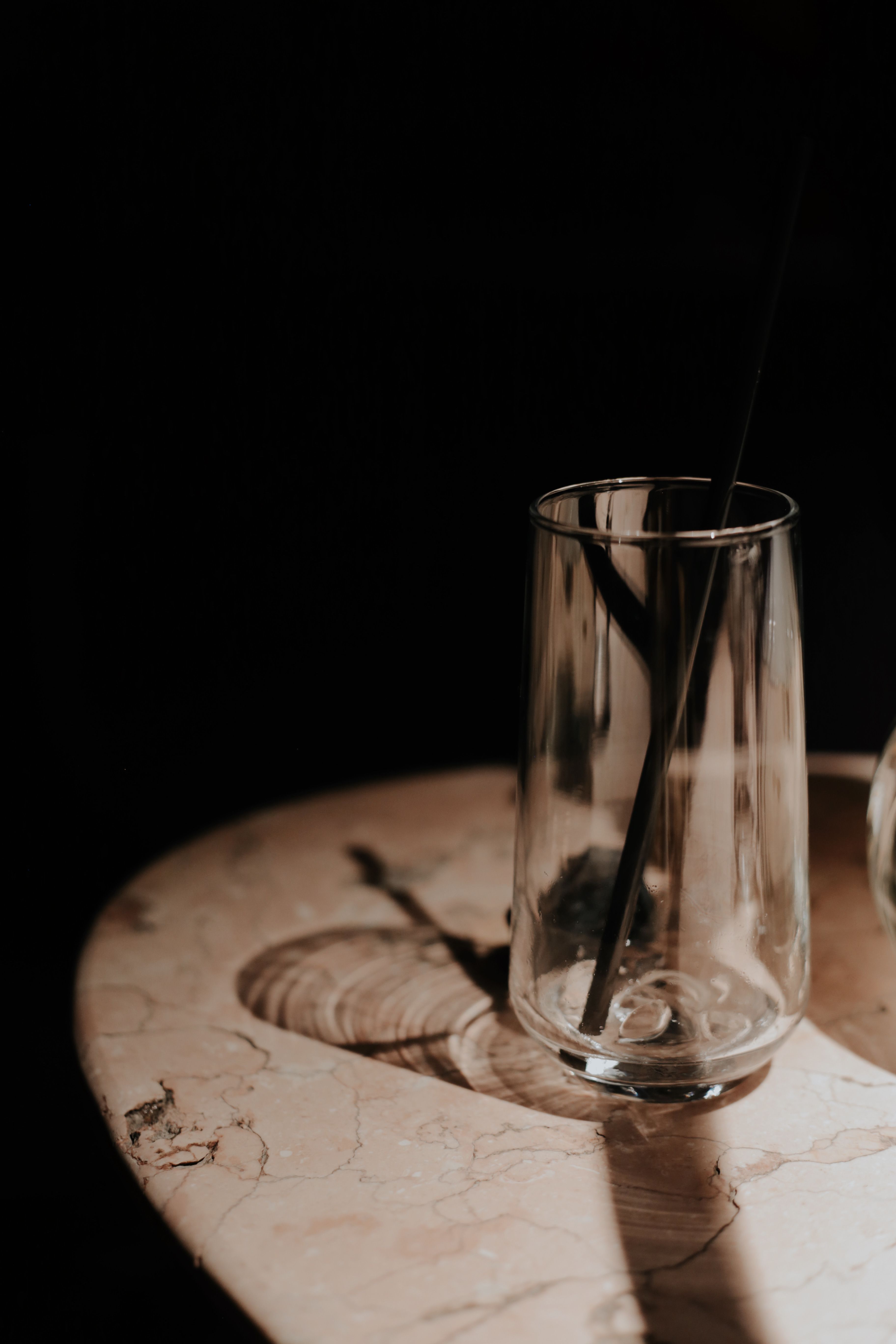 Glass with a straw on a marble tabletop — photo by Margarita on Pexels