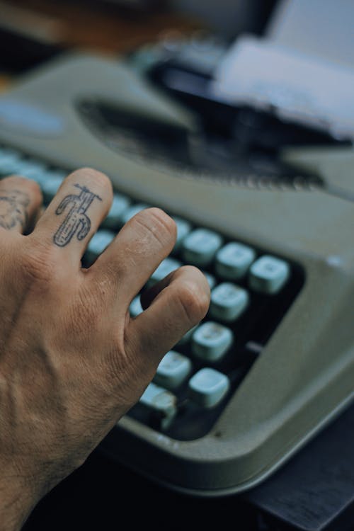 Person Typing On A Typewriter