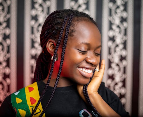 A Woman Smiling with Braided Hairstyle