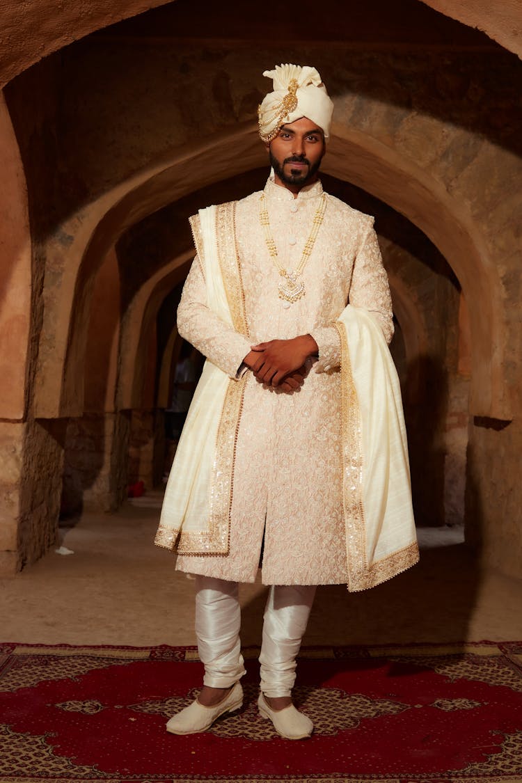 Photo Of A Standing Groom In White Wedding Suit