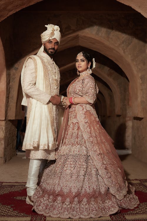 Woman and Man Posing Together in Traditional Clothing