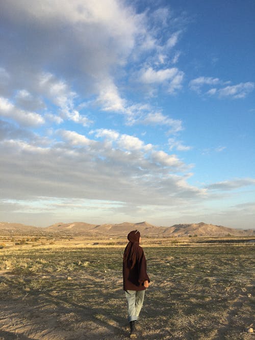 Woman Walking on a Field 