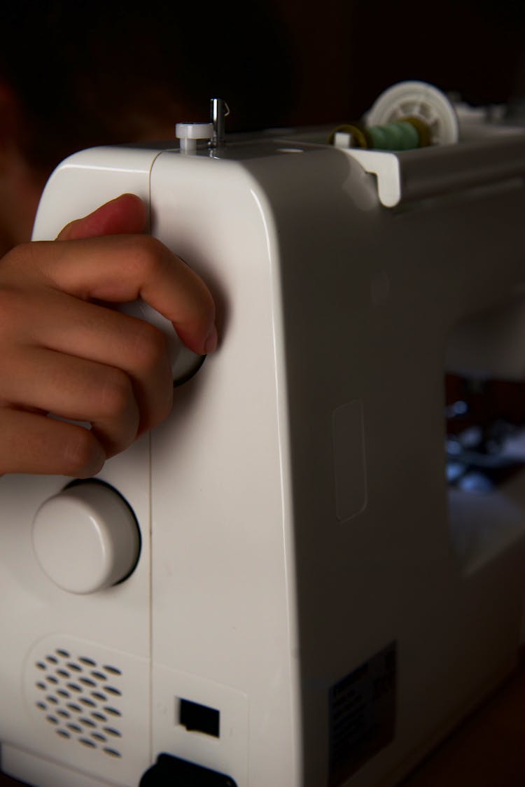 A Person Using A Sewing Machine