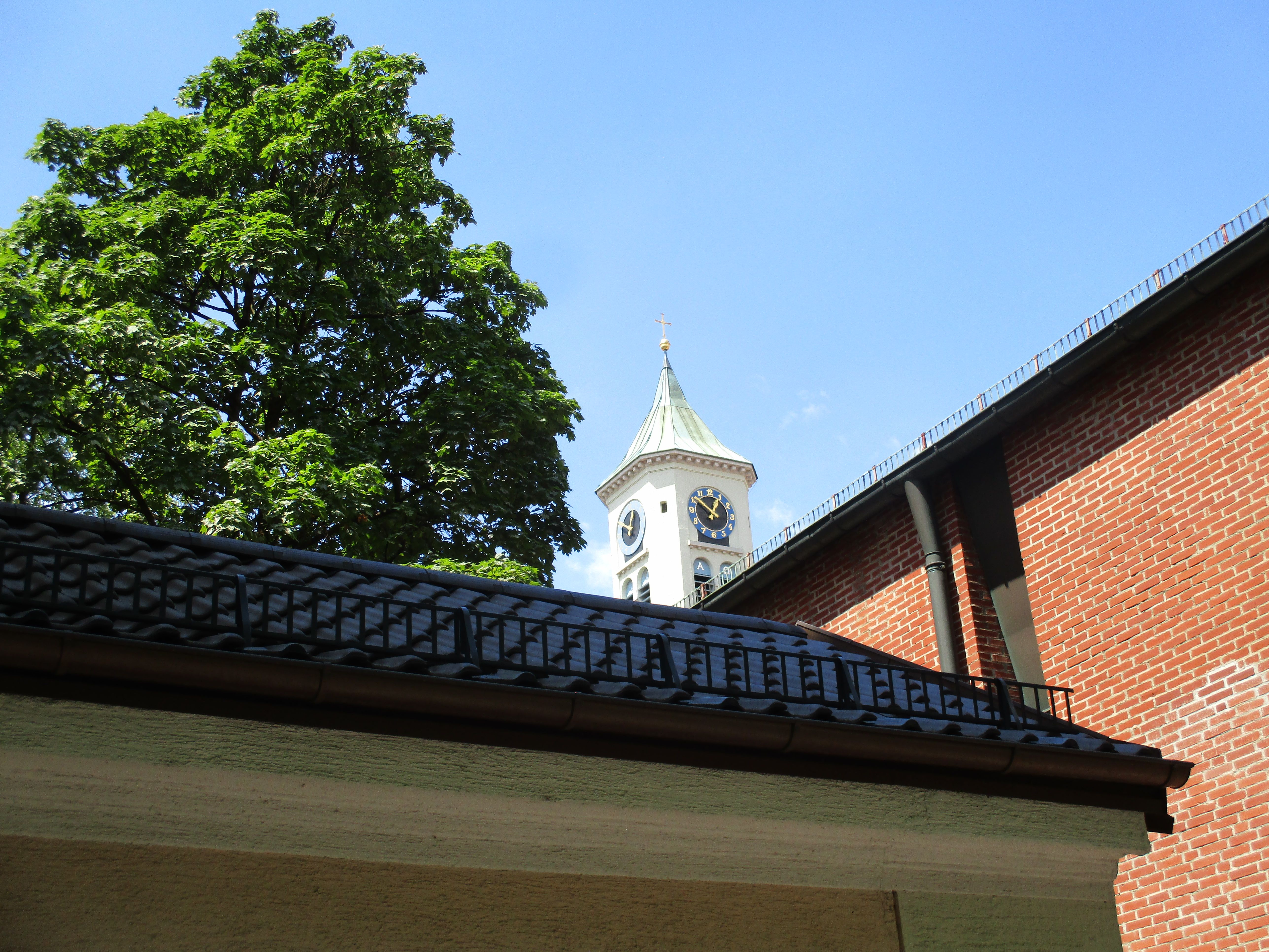 House Roof Beside Church Tower With Clock Under Blue Sky · Free Stock Photo