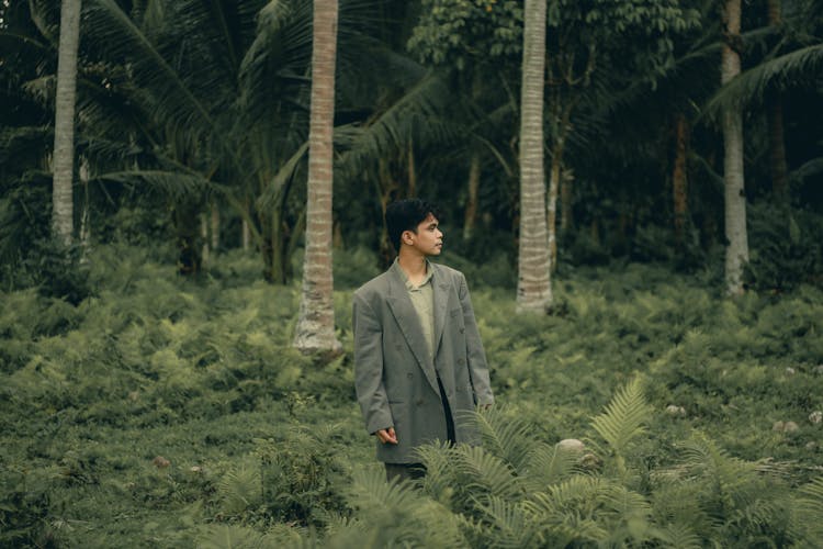 Elegant Man Walking Through Tropical Forest