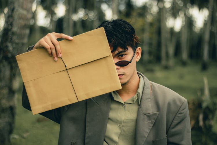 A Man Holding An Envelope