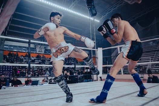 Two kickboxers engage in a dynamic match, showcasing power and agility in a packed arena.