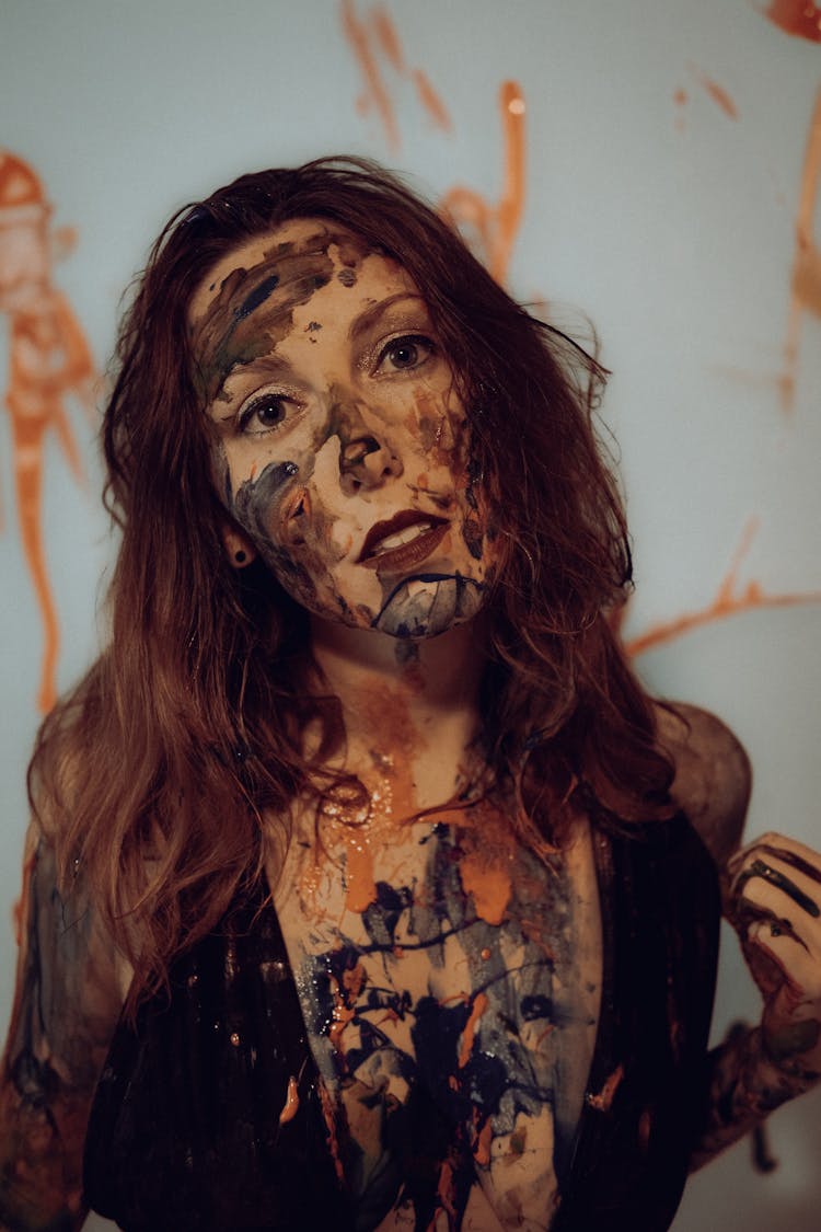 A Woman With Paint On The Face And Body