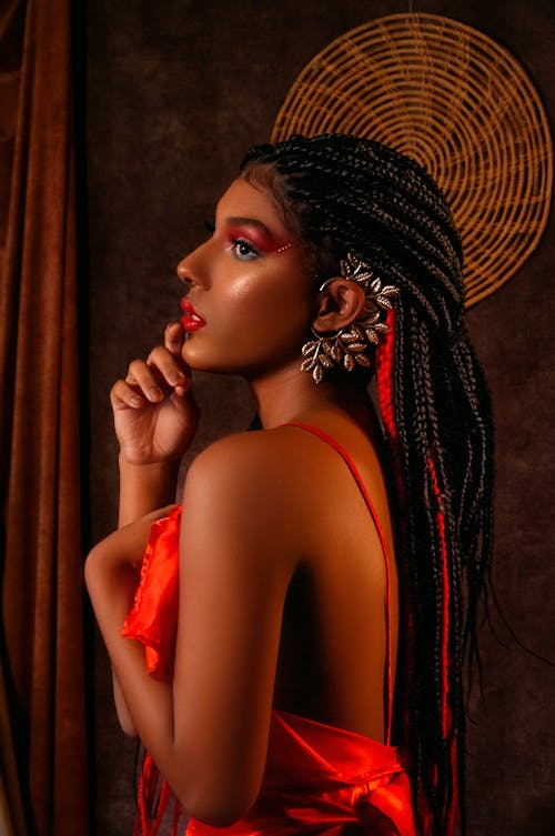 Woman in Braided Hair Posing in Red Dress and Earing Accessory