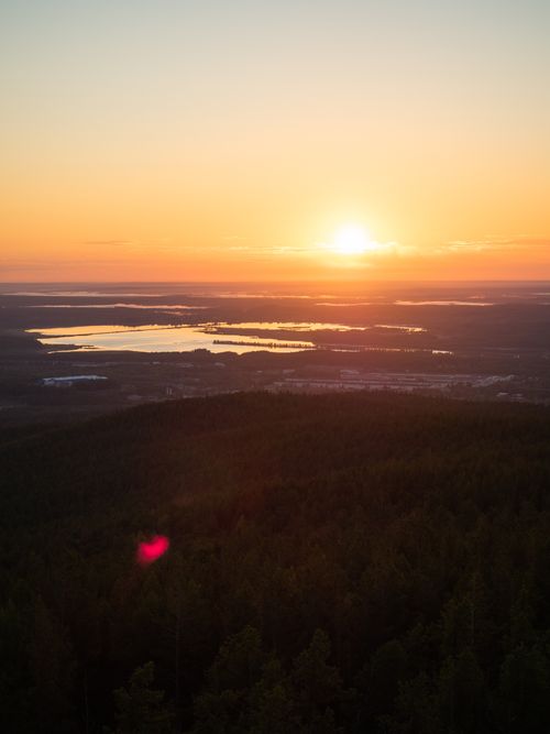 Free Captivating sunset view over lakes and hills, radiating golden and warm hues. Stock Photo