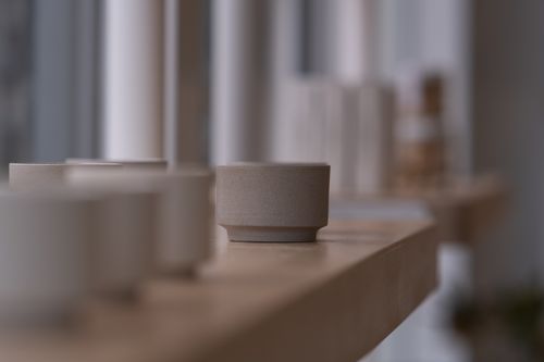 Free Minimalist design with ceramic pots on a wooden shelf by a window. Stock Photo