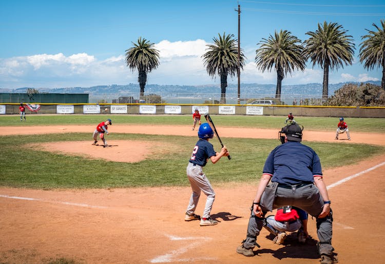 Children Playing Baseball On Field