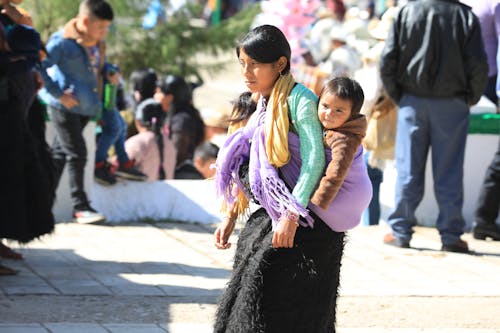 A Woman Carrying a Baby on Her Back