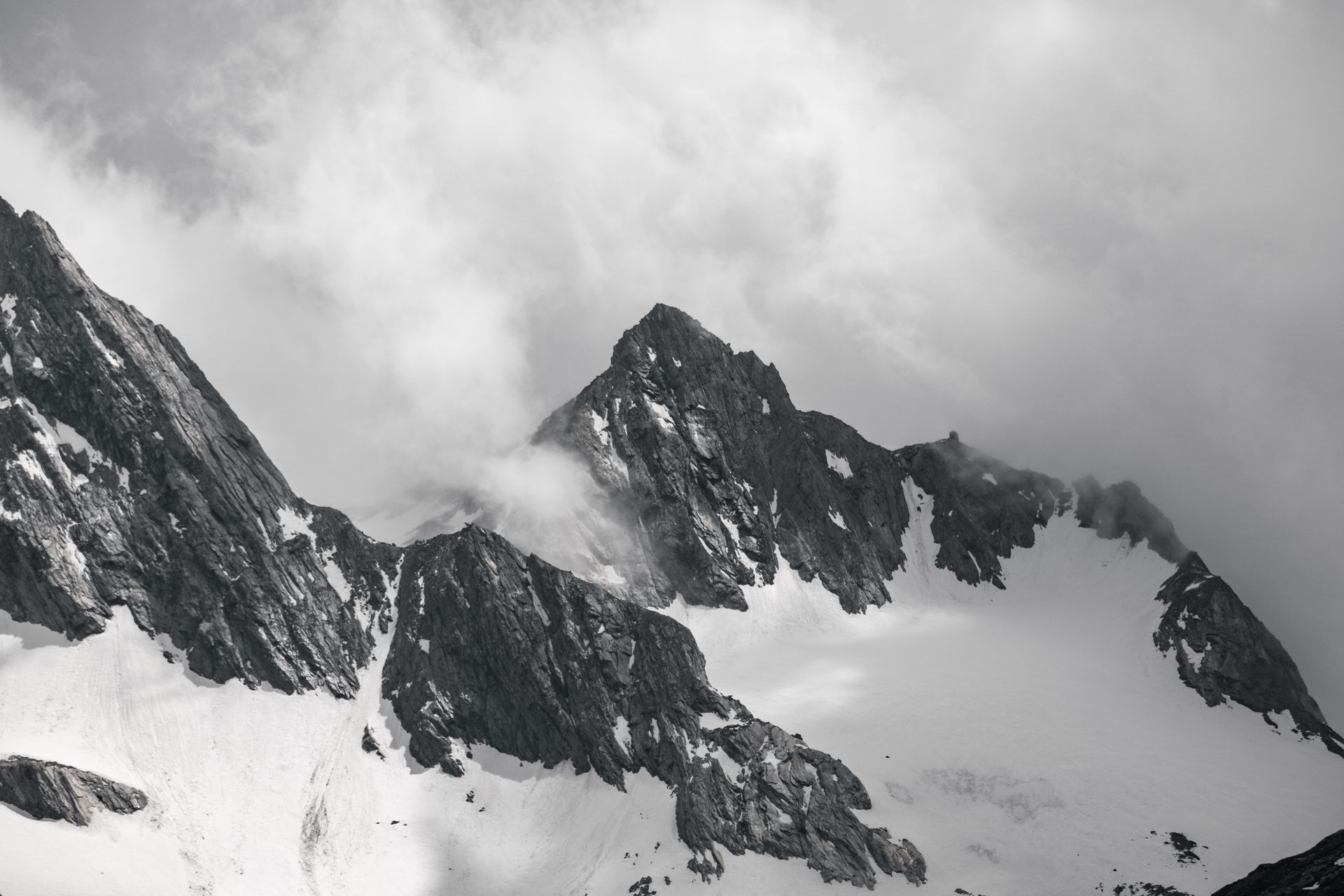 Snow Covered Mountain Under Cloudy Sky