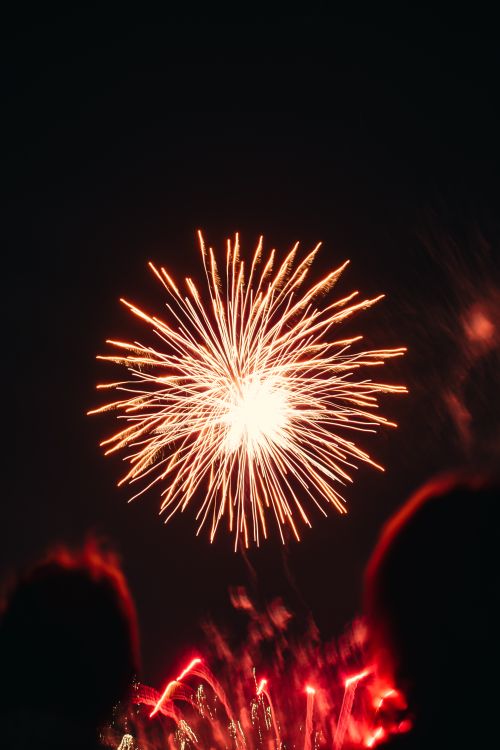 Free A spectacular fireworks display with bright sparks illuminating the dark sky, creating a festive atmosphere. Stock Photo