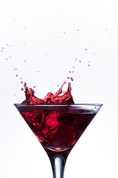 Close-up of a Splashing Red Drink in a Cocktail Glass