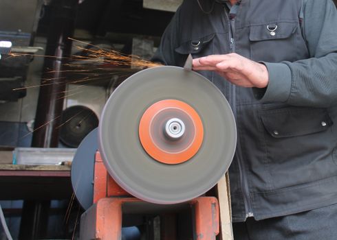 Man Grinding in a Workshop 