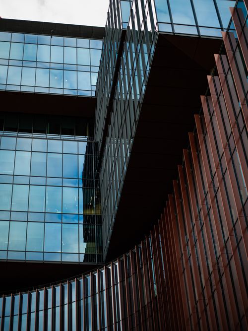 Free High-rise urban glass building with unique architectural design and reflections intricate structures. Stock Photo