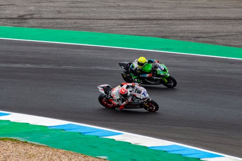 Free Motorcycles Racing on Race Track Stock Photo