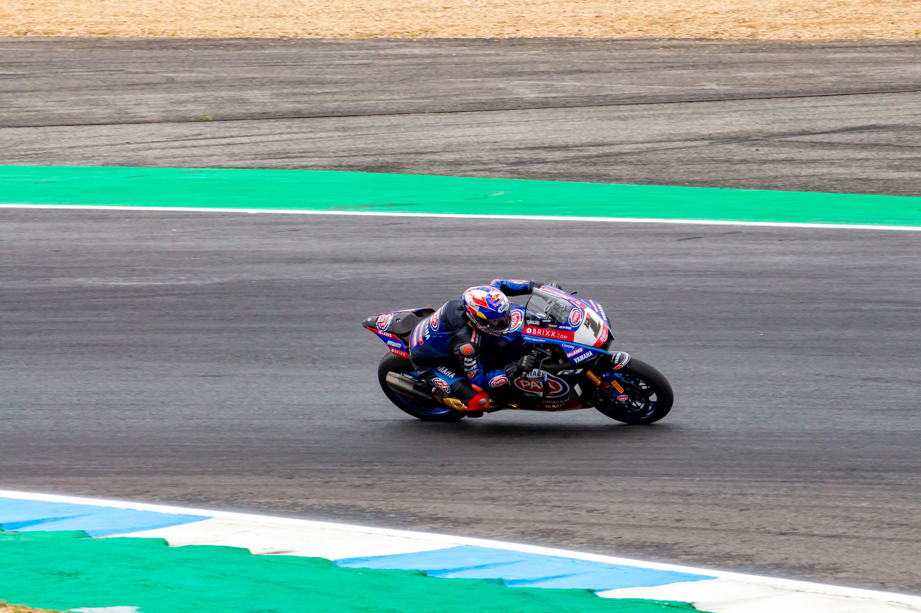 Exciting capture of a motorcycle racer leaning into a turn on a race track in Portugal.