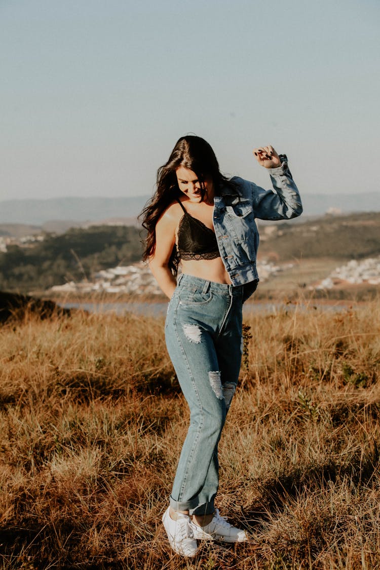 Woman Posing In Jacket, Bra And Jeans