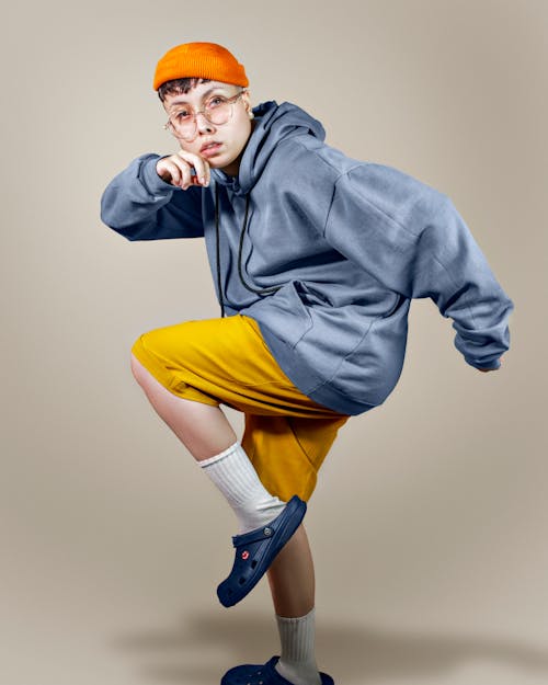 Free Man in Blue Hoodie and Yellow Shorts Wearing Black Sunglasses Stock Photo