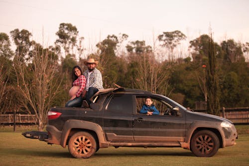 Man with a Pregnant Woman in the Back of the Pick-up Truck 