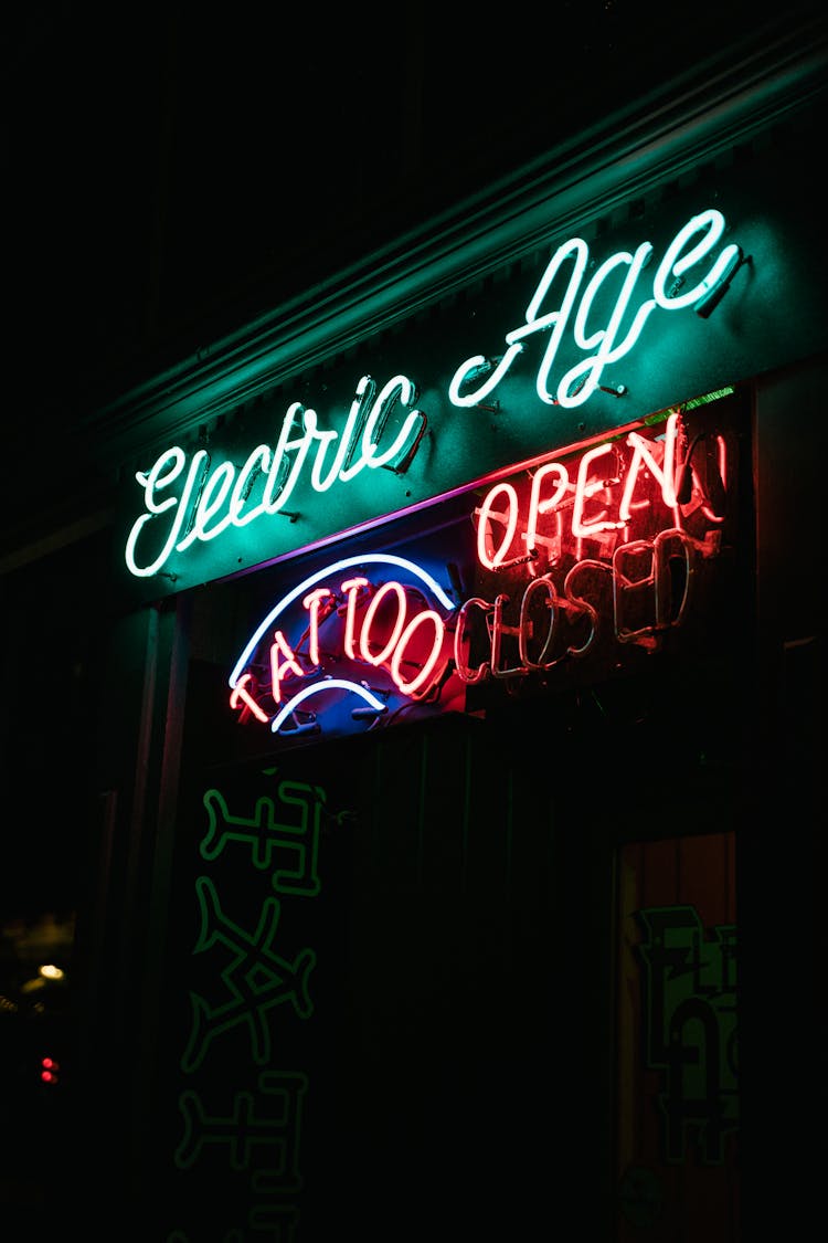 Neon Sign Of A Tattoo Studio Glowing At Night