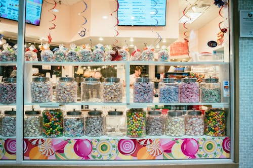 Assorted Candies in Glass Jars Display on Store