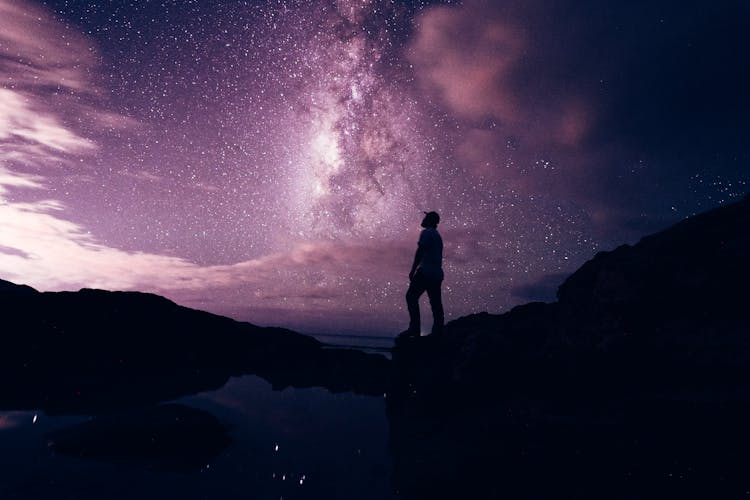 Man Looking At Purple Sky At Night