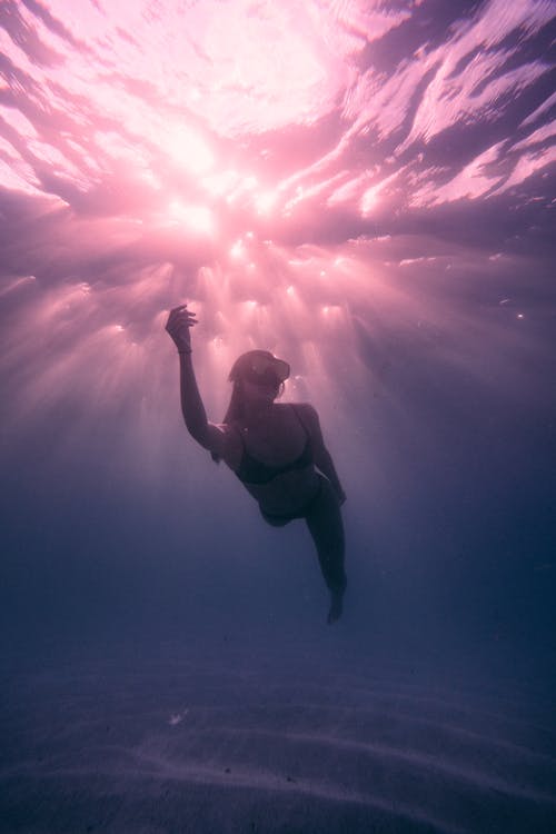 Free A Woman Swimming Underwater Stock Photo
