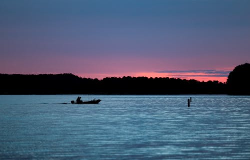 Fisherman on a Boat Cruising the Lake